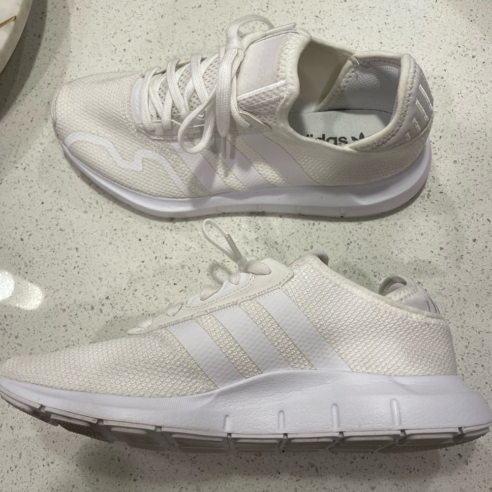 Men’s 9.5 adidas white running shoe.